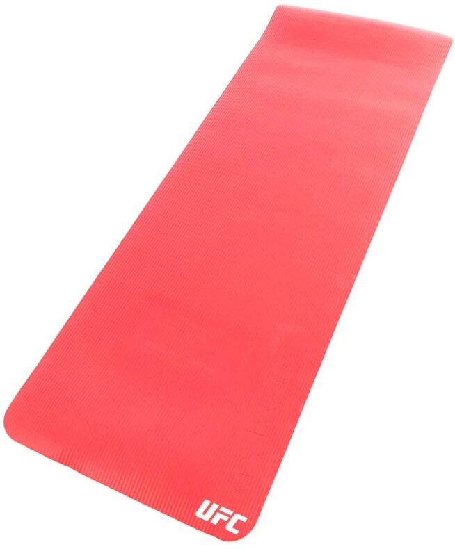 This bold Red UFC training mat is an essential fitness tool perfect for multiple uses. The portability and durability of this mat allow you to work out nearly anywhere at any time and store it when not in use. Helping to provide stability and added cushion, it allows you to comfortably perform numerous exercises including sit-ups, push-ups, burpees, and Planks. The non-slip textured surface, soft yet durable design and convenient carry strap combine for a superior training mat.