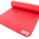 This bold Red UFC training mat is an essential fitness tool perfect for multiple uses. The portability and durability of this mat allow you to work out nearly anywhere at any time and store it when not in use. Helping to provide stability and added cushion, it allows you to comfortably perform numerous exercises including sit-ups, push-ups, burpees, and Planks. The non-slip textured surface, soft yet durable design and convenient carry strap combine for a superior training mat.